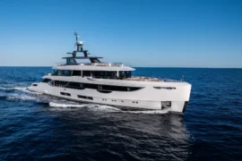 Side profile of Cada Dia underway, highlighting her modern exterior lines, generous deck spaces, and elegant long-range cruising presence at sea.