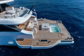 Expansive aft swim platform on Cada Dia with teak decking, spa pool, and direct water access for a resort-style yachting experience at sea.